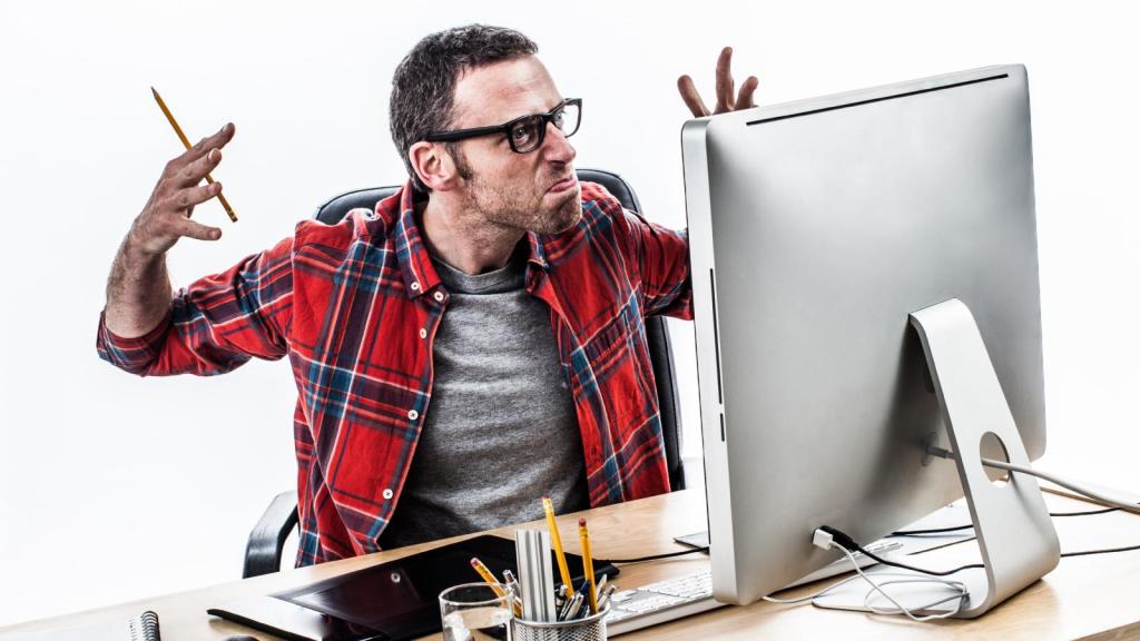 man annoyed at his computer