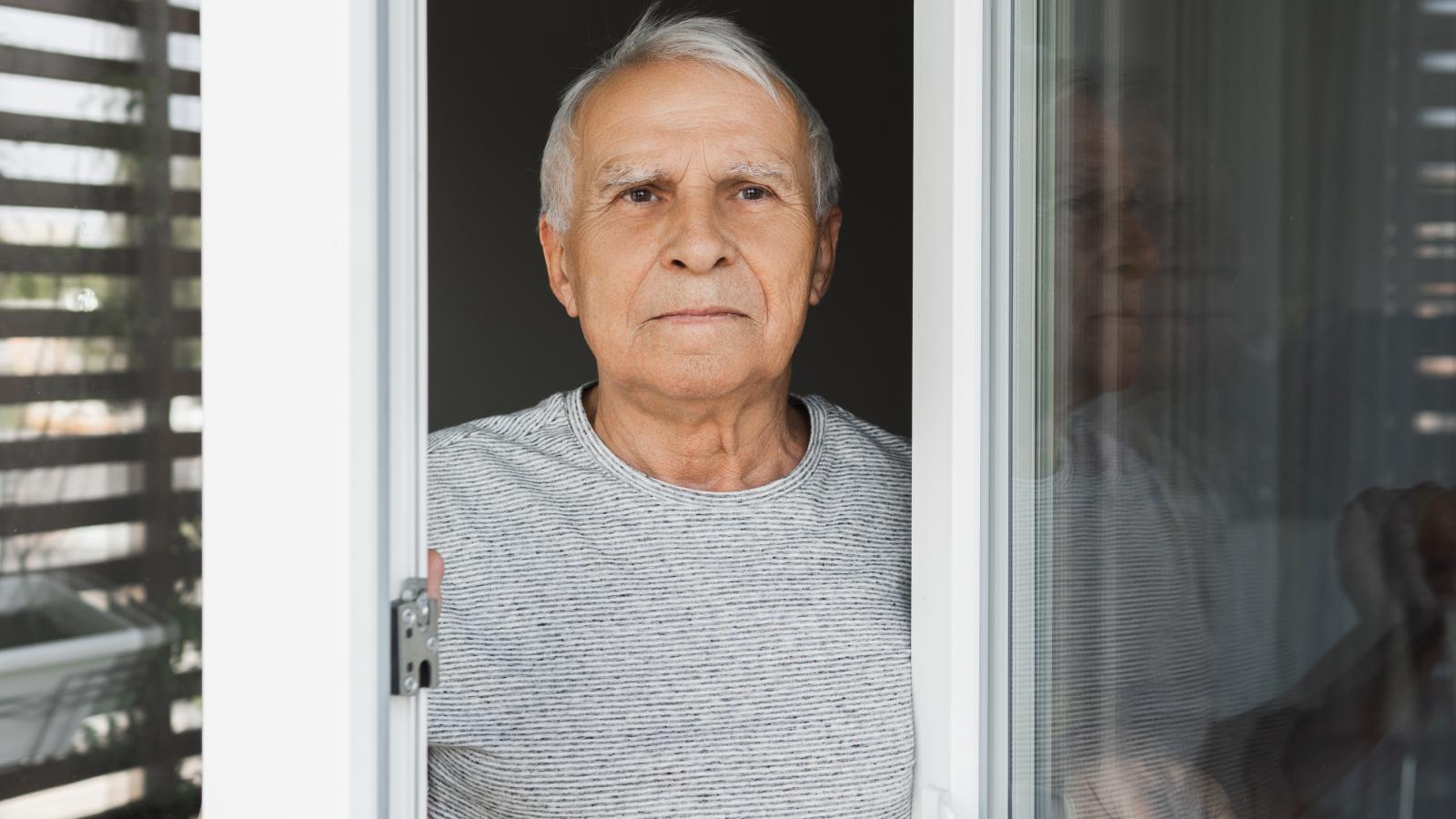 man looking out a window
