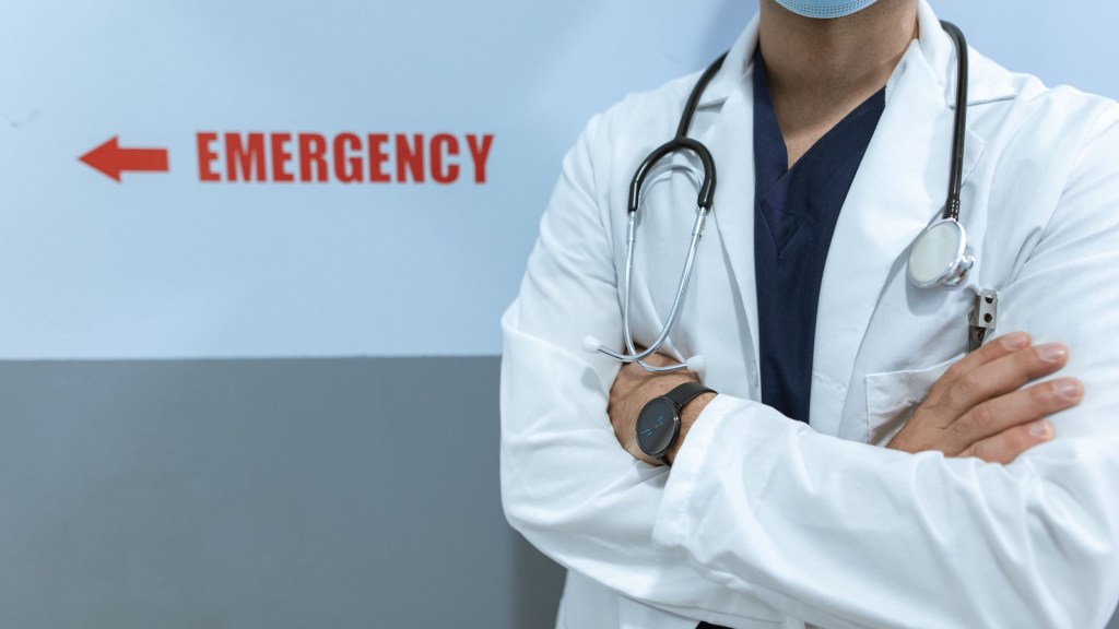 emergency room sign with doctor crossing his arms