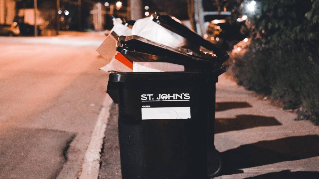 full trash can at night