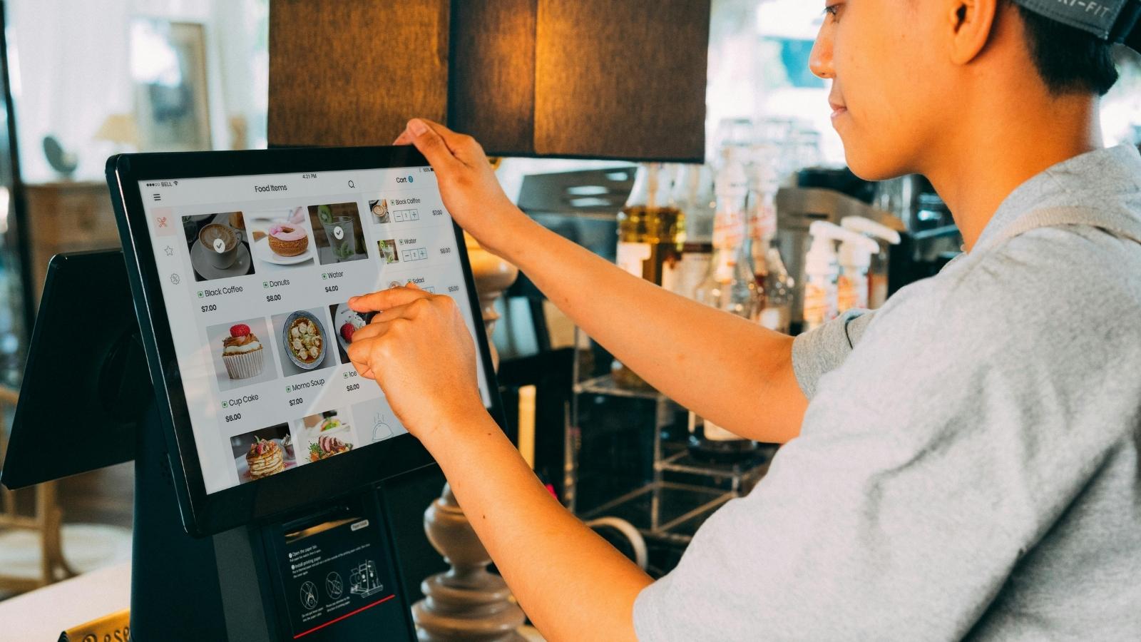 grocery store cashier touching screen