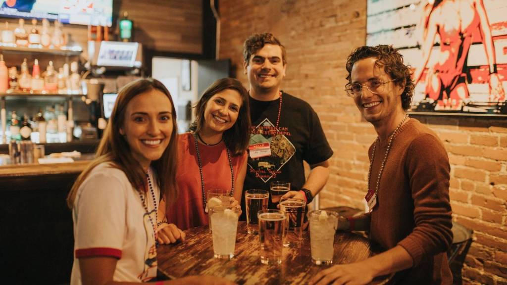 group of friends gathered around bar