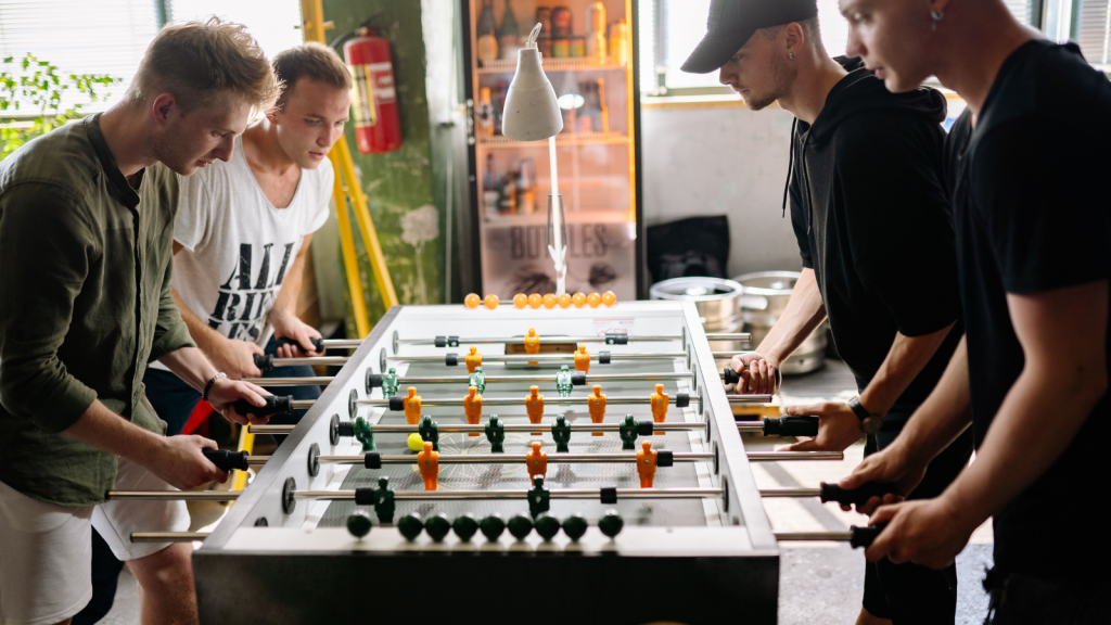 group of men playing foosball