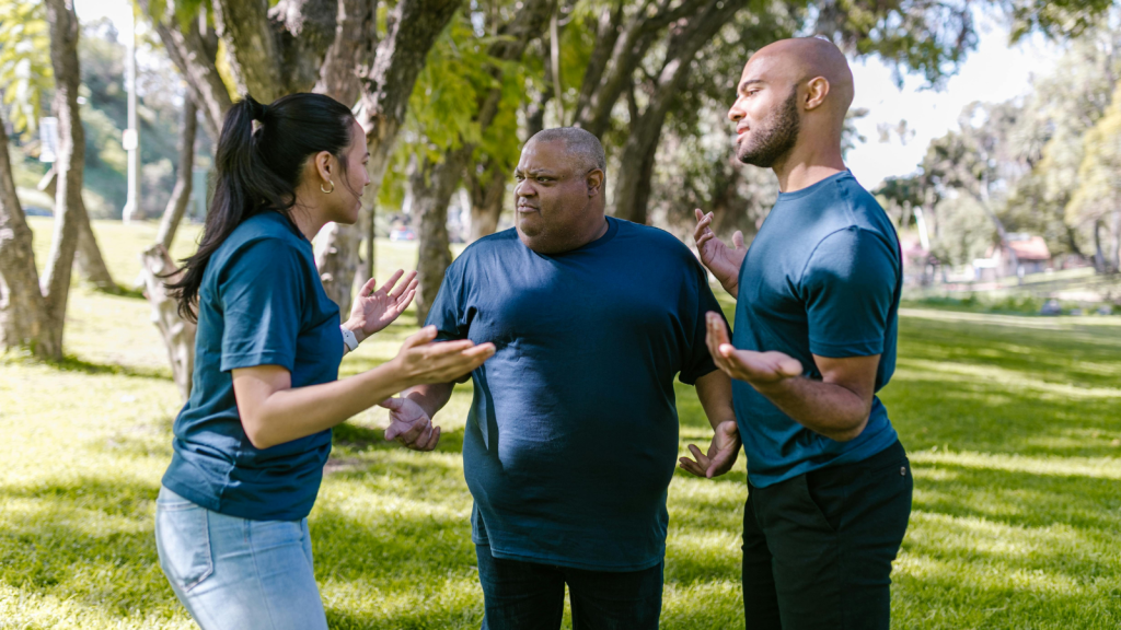 group of people arguing in the park