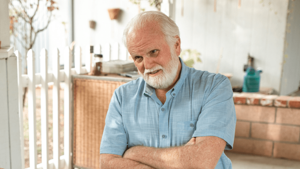 grumpy old man crossing his arms