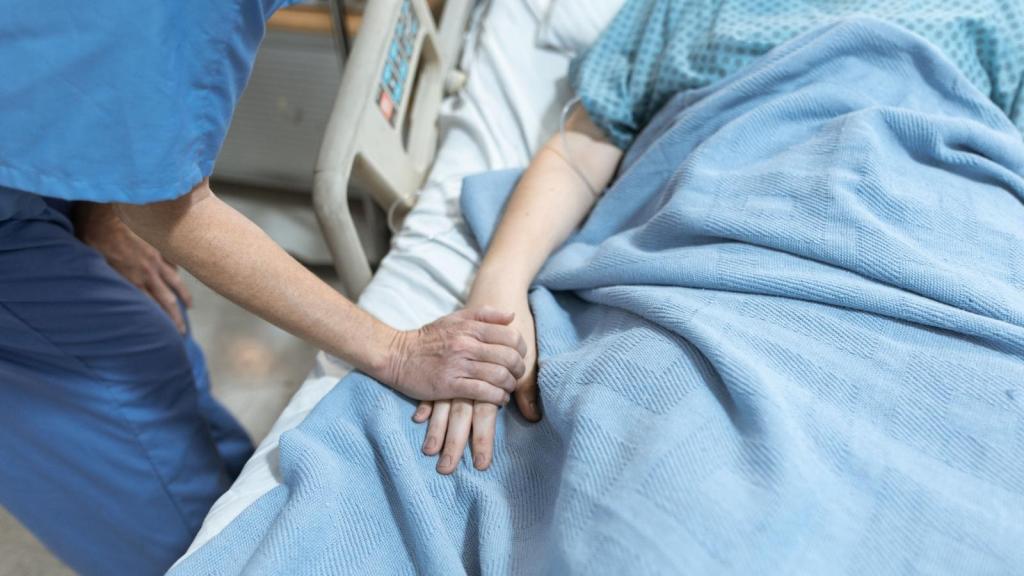 hospice nurse holding hand