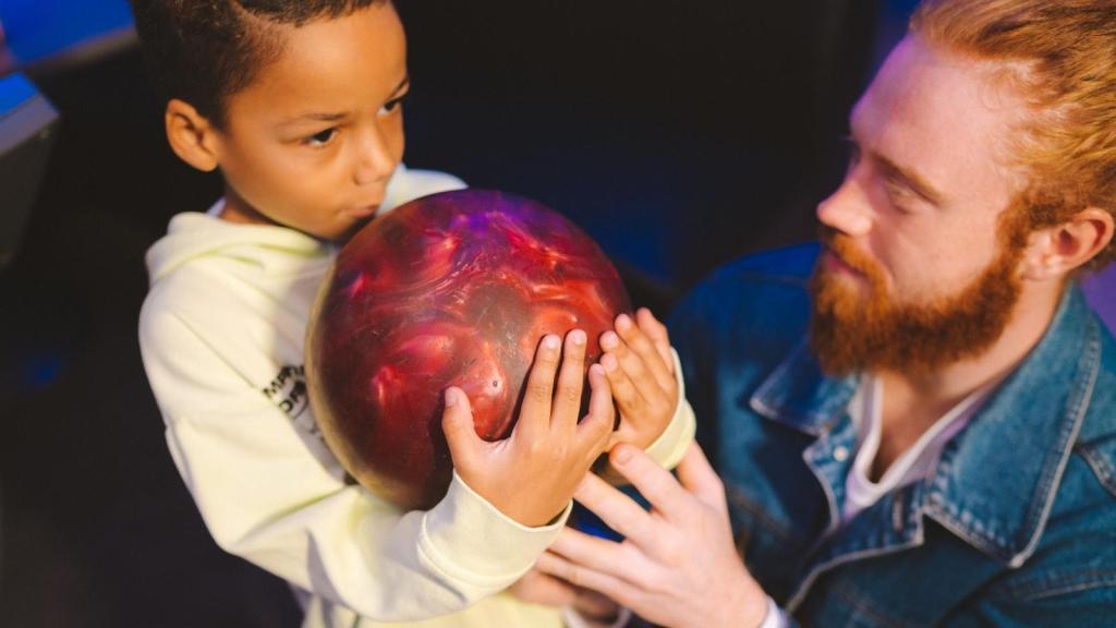 kid holding a bowling ball