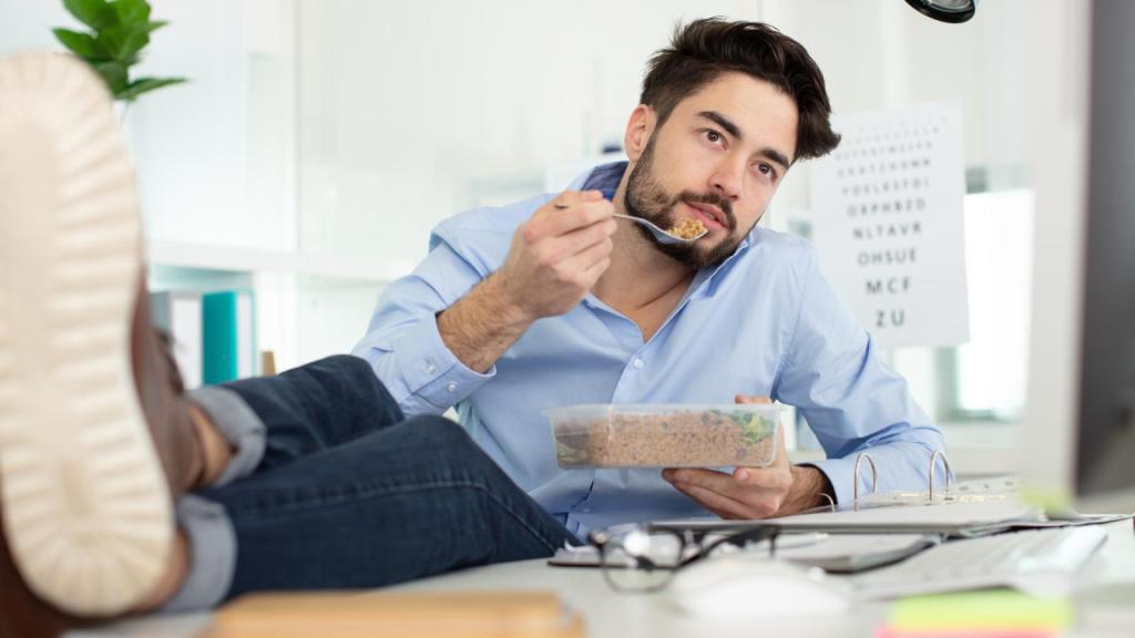 man eating at his desk
