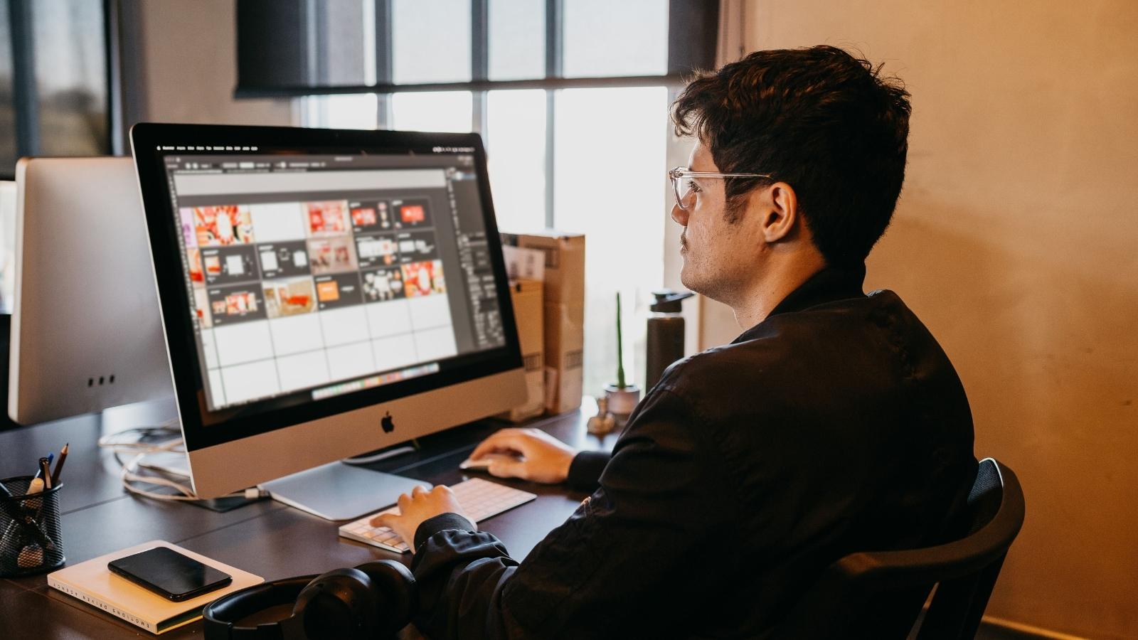 male graphic designer working at his desk