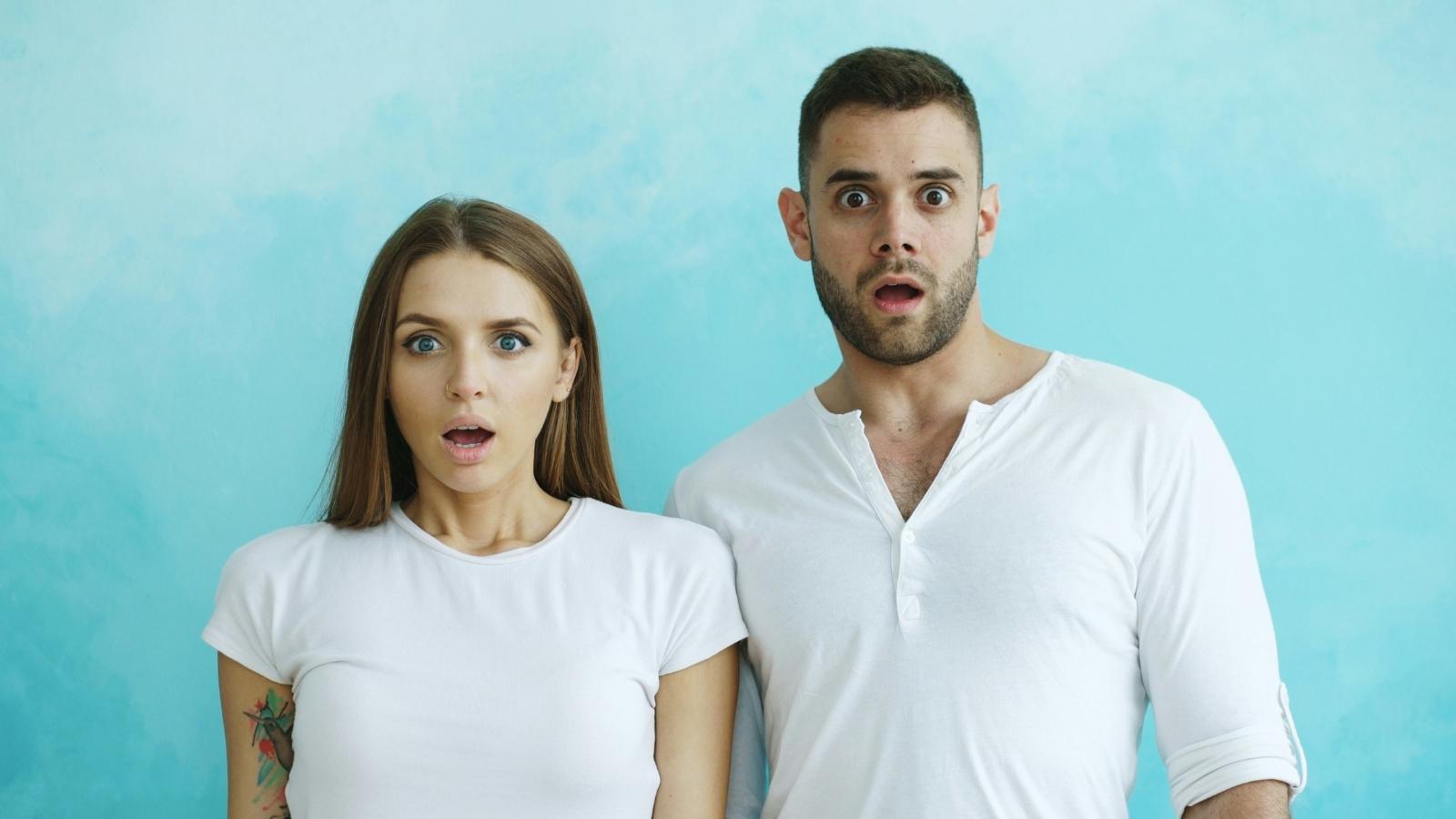 man and woman looking shocked at the camera
