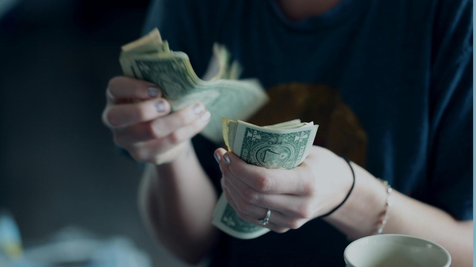 man holding a stack of cash