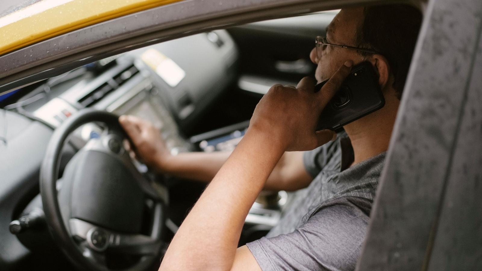 man talking on the phone in the car