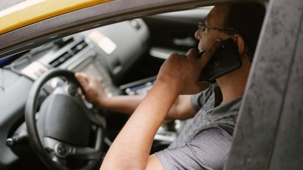 man talking on the phone in the car