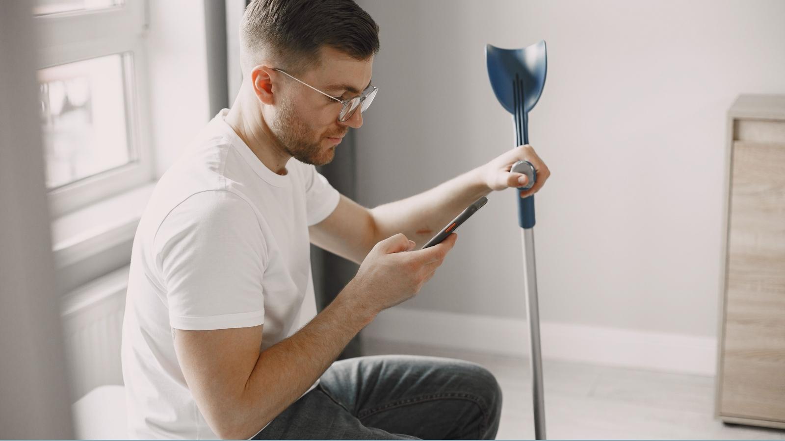 He Changed His Workout Because It Wasn’t Accessible—Then His Dad Made a Hurtful Comment man wearing glasses using crutches