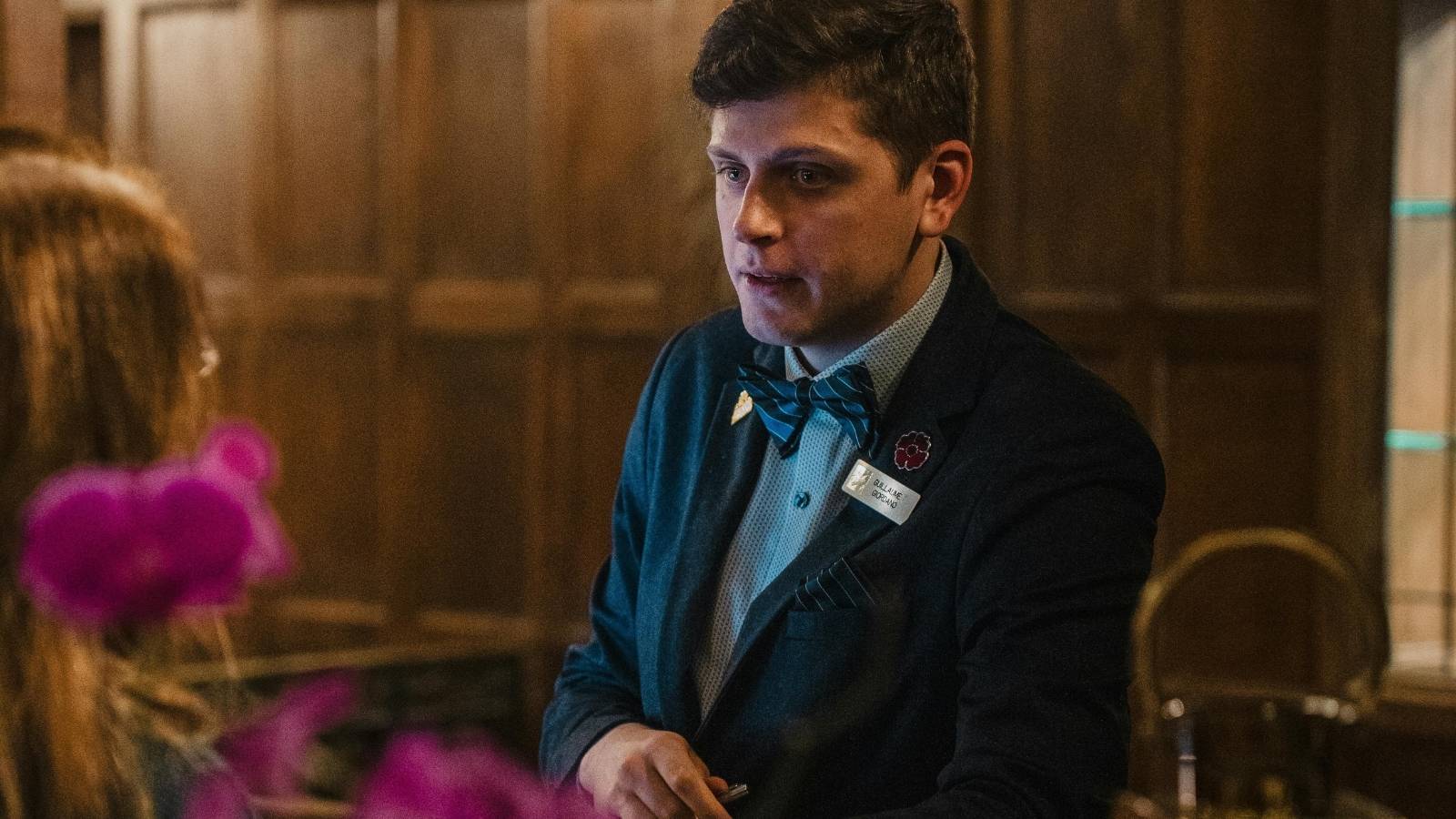 man working at front desk hotel
