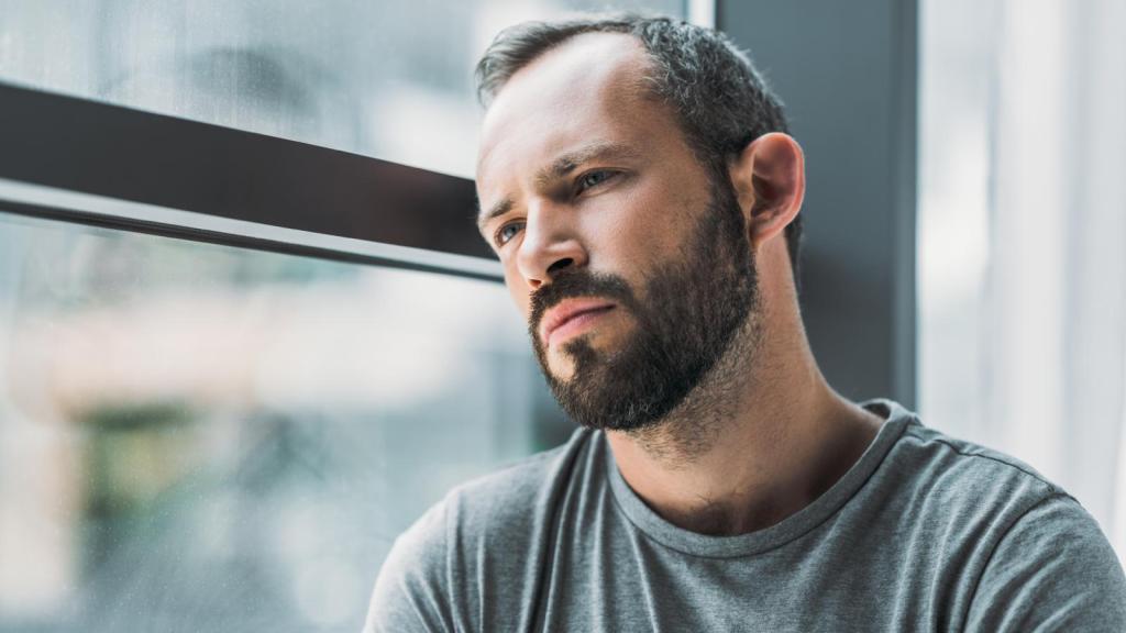 man looking out a window