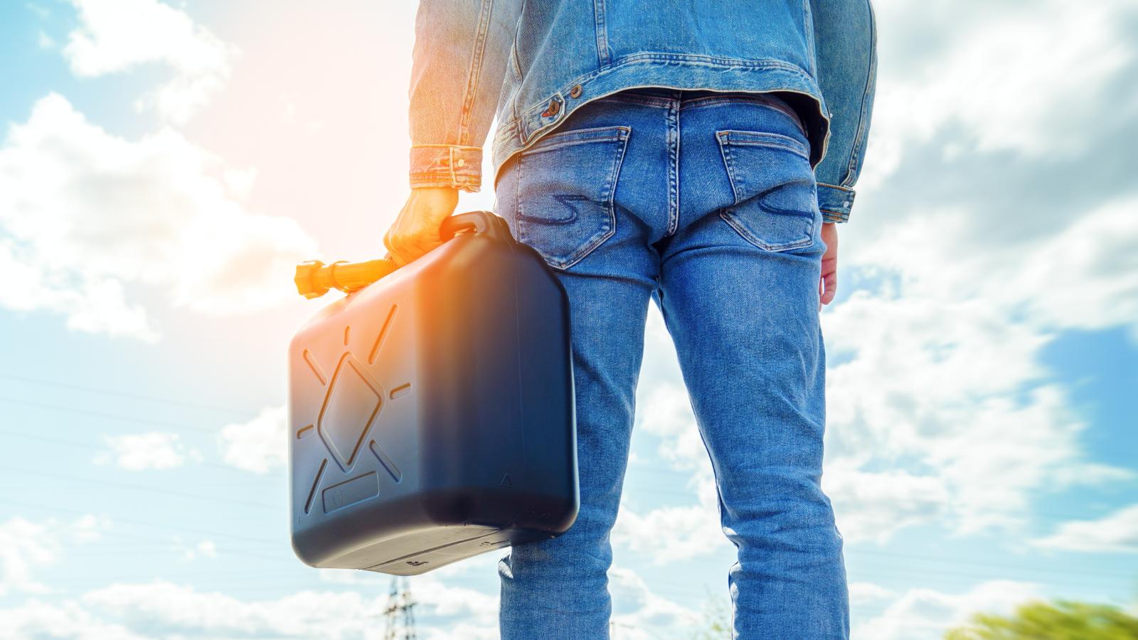 Man Serves Up Gross Revenge on Neighbor Who Kept Stealing Gas From His Yard man holding a gas can