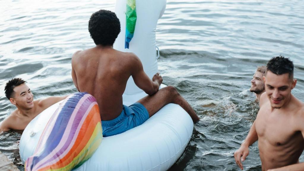 men swimming in lake