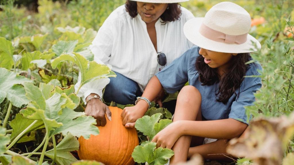 mother and daughter visiting a pumpkin patch