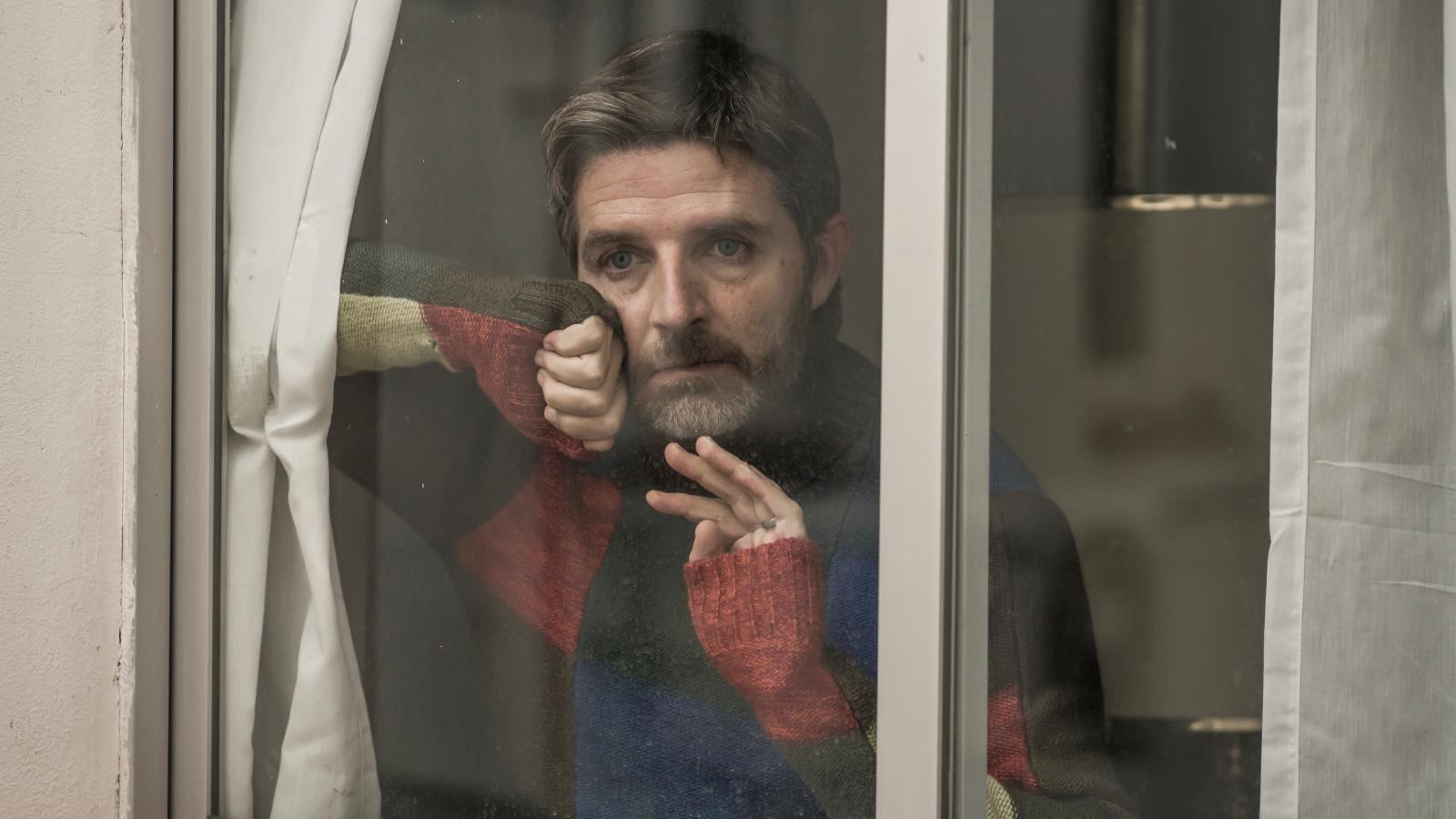 Late Night Mariachi Bands Trigger Explosive Noise Dispute Between Tired Neighbors man looking a window