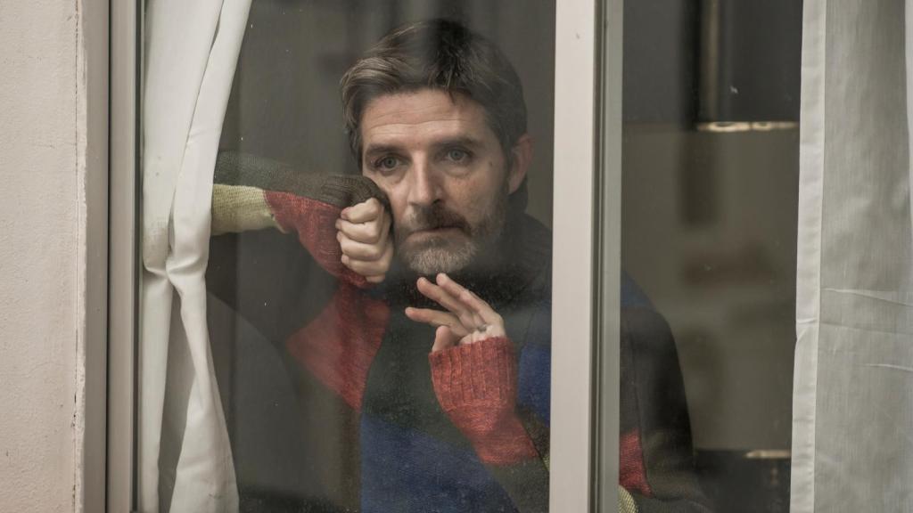 man looking a window