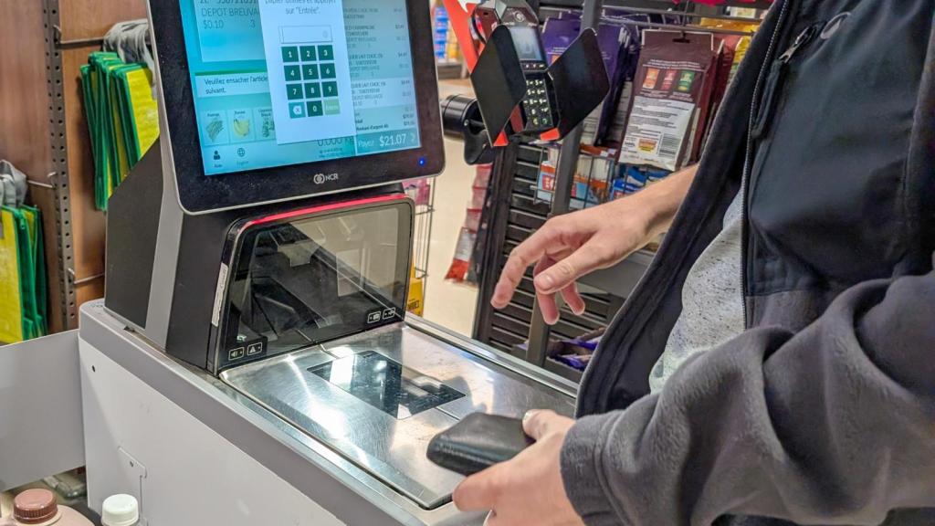 man at a self-checkout register