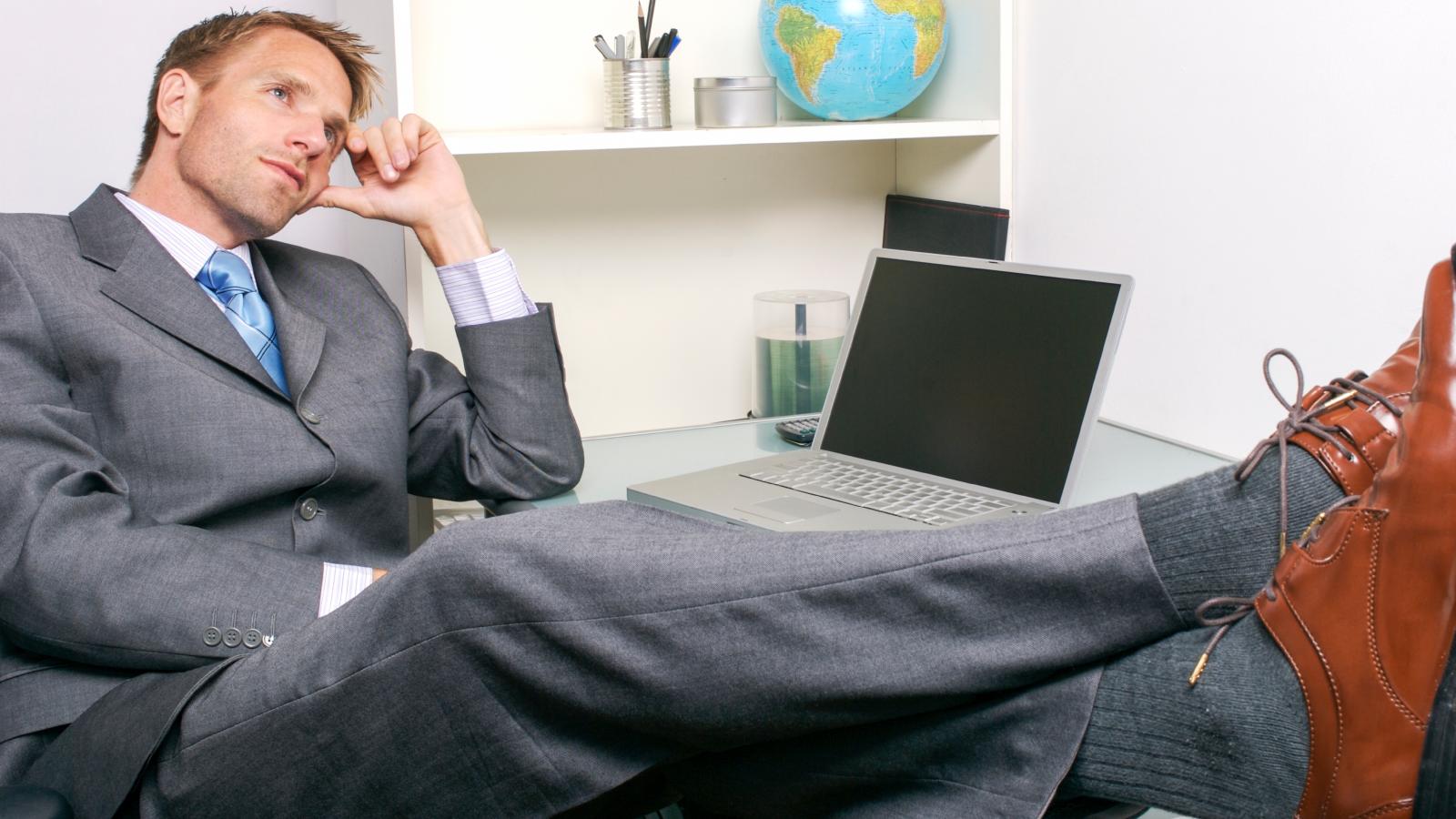 man with his feet up on desk