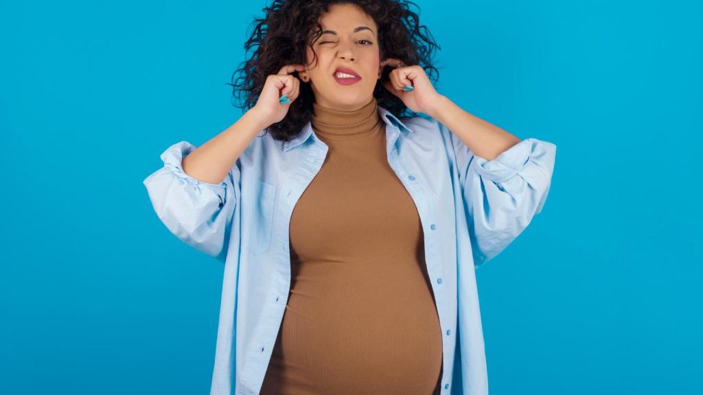 woman plugging her ears