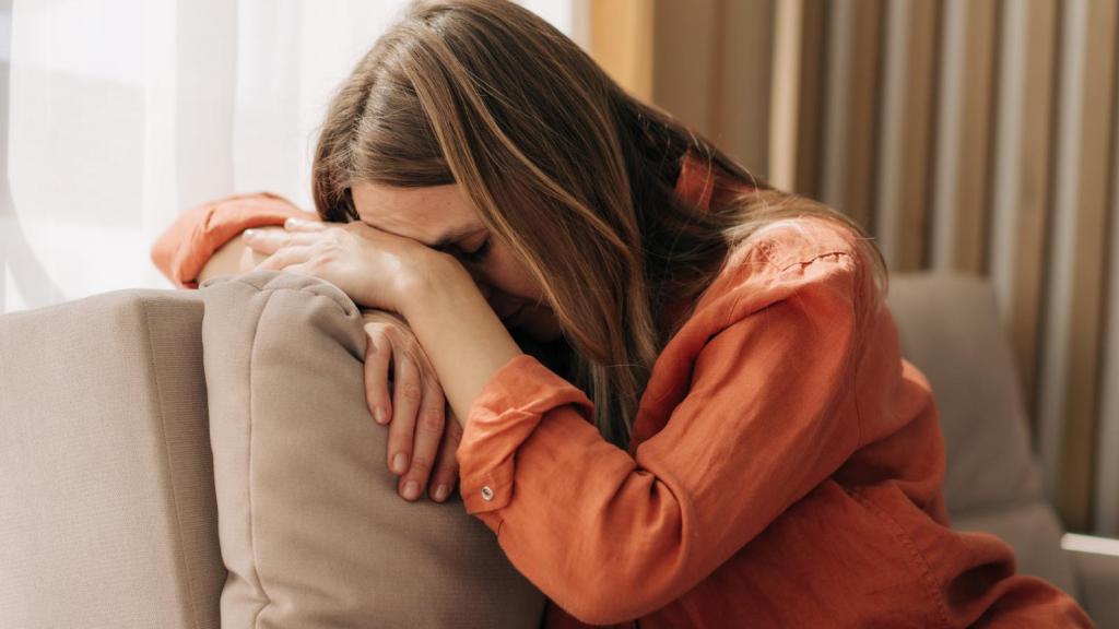 woman with her head on a couch
