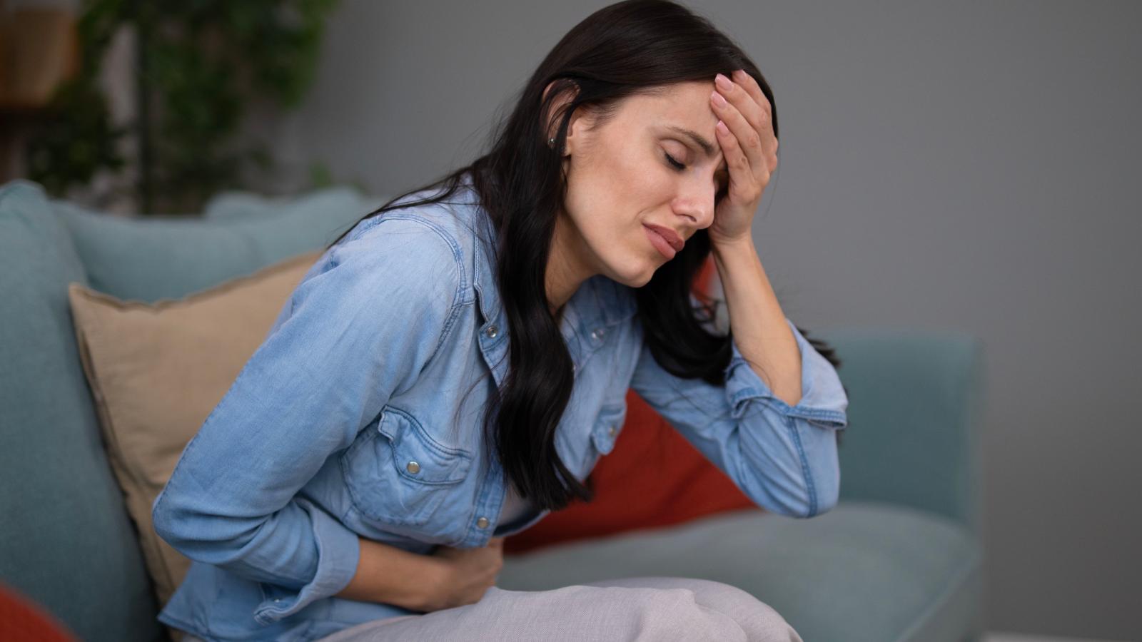 An Aggressive Neighbor Has Sent Their Anxiety Soaring — and Theyre Struggling to Find a Way Forward woman sick on her couch