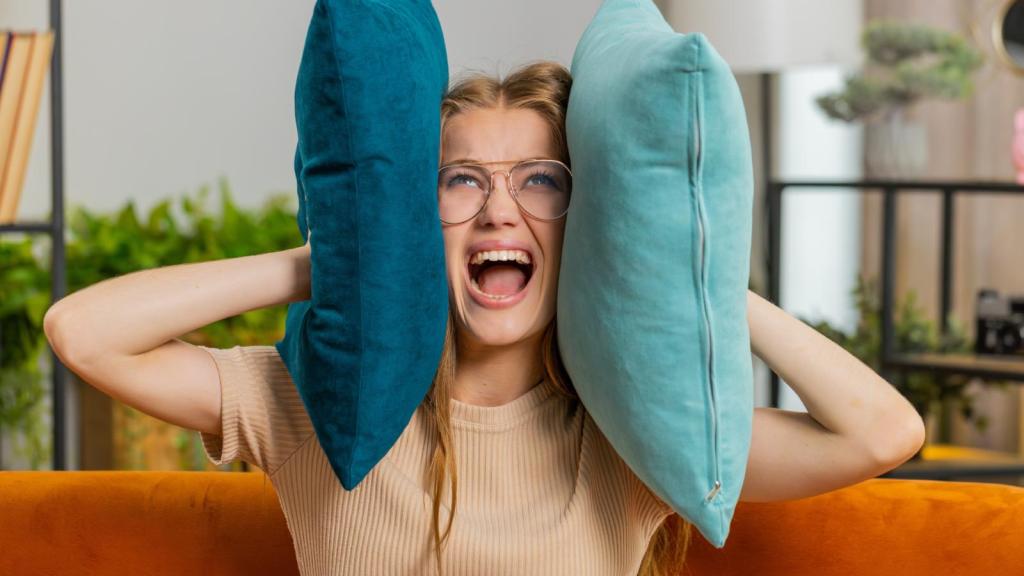 woman covering her ears