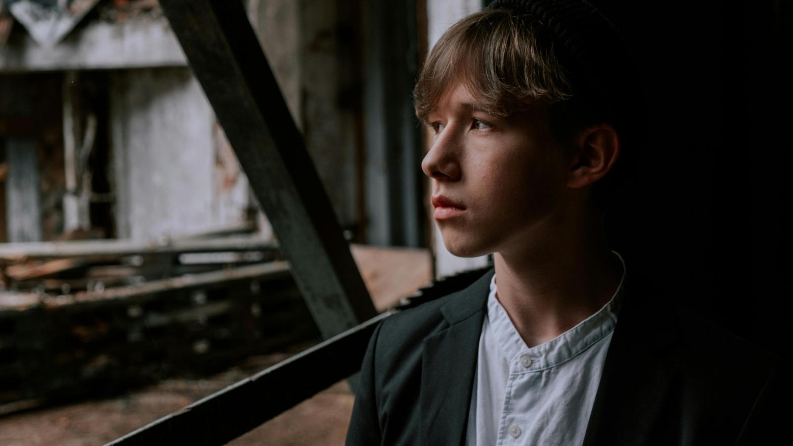 pensive teenager looking out the window