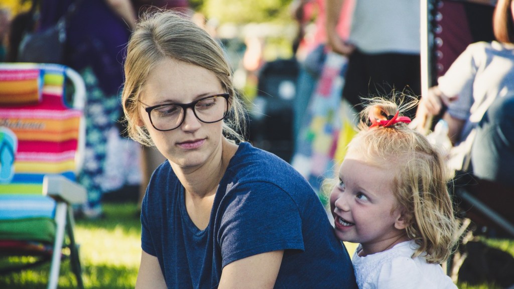 a woman looking down at a young child