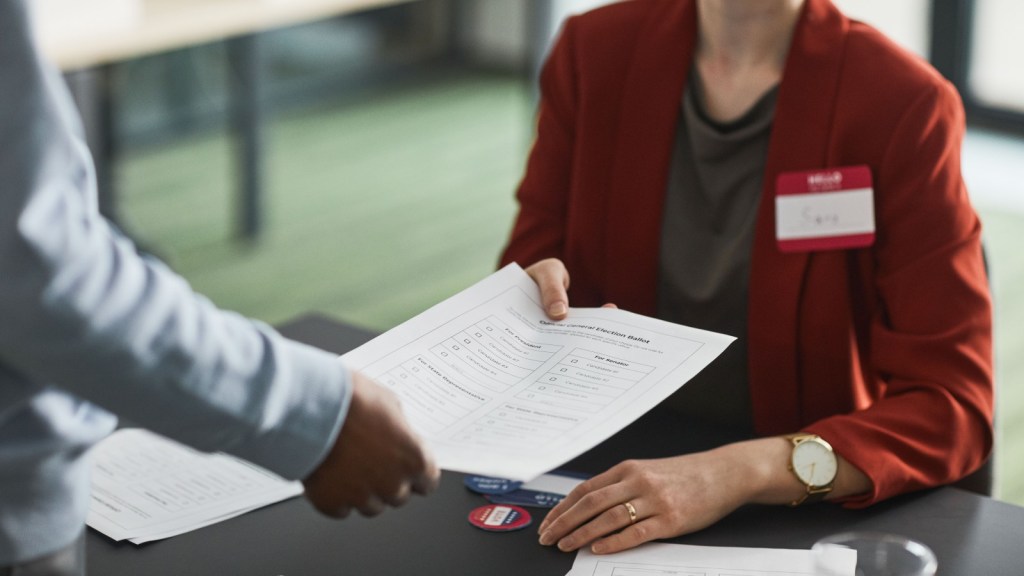 a person handing a document to someone