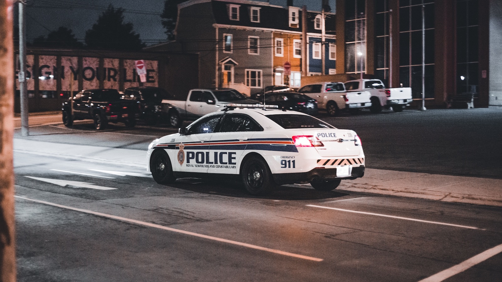cop car parked in a neighborhood