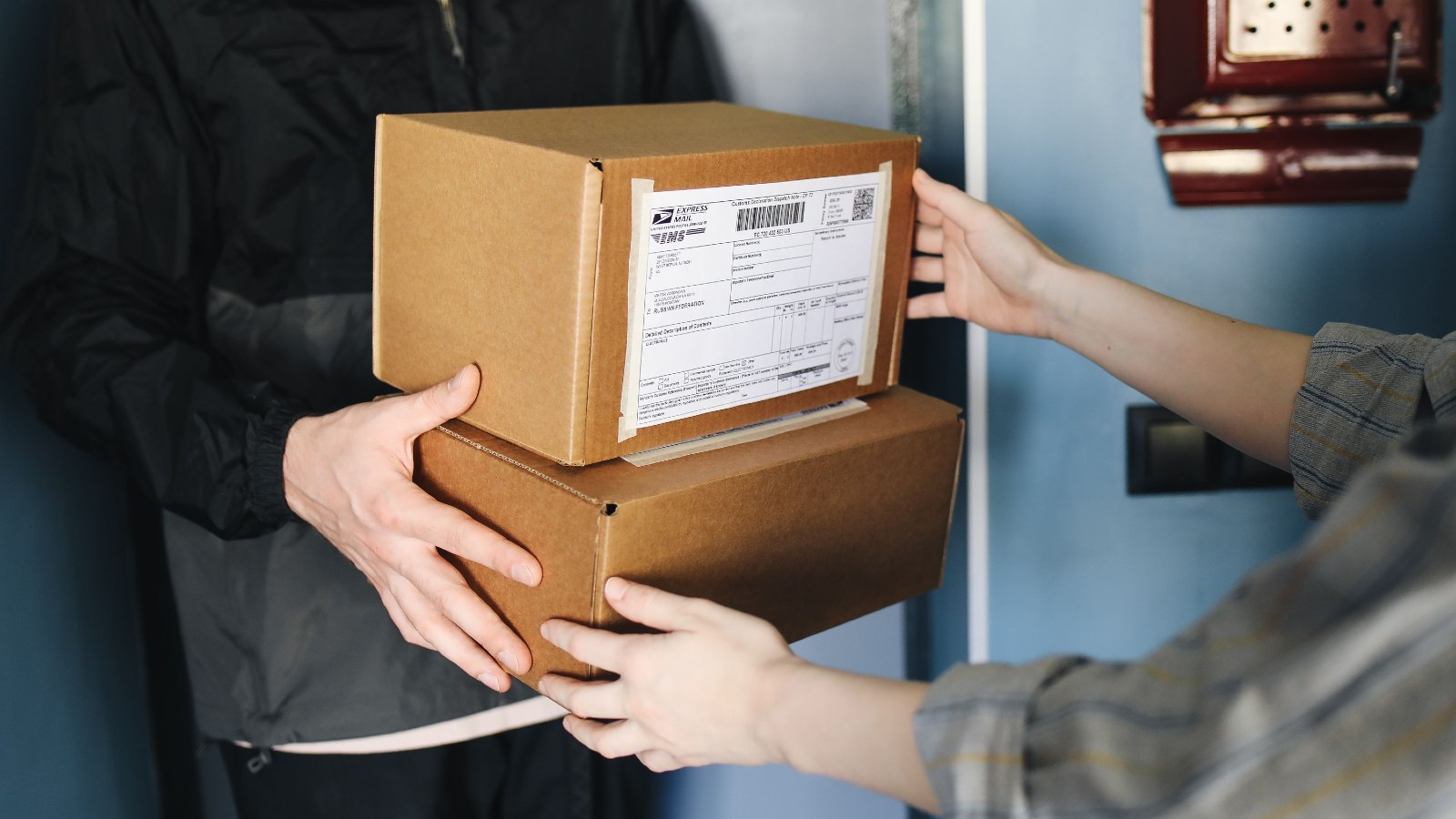 a person handing boxes to another person