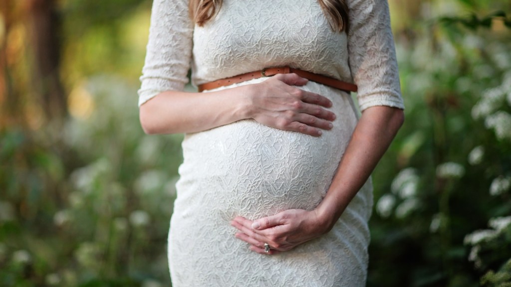 woman holding her pregnant belly