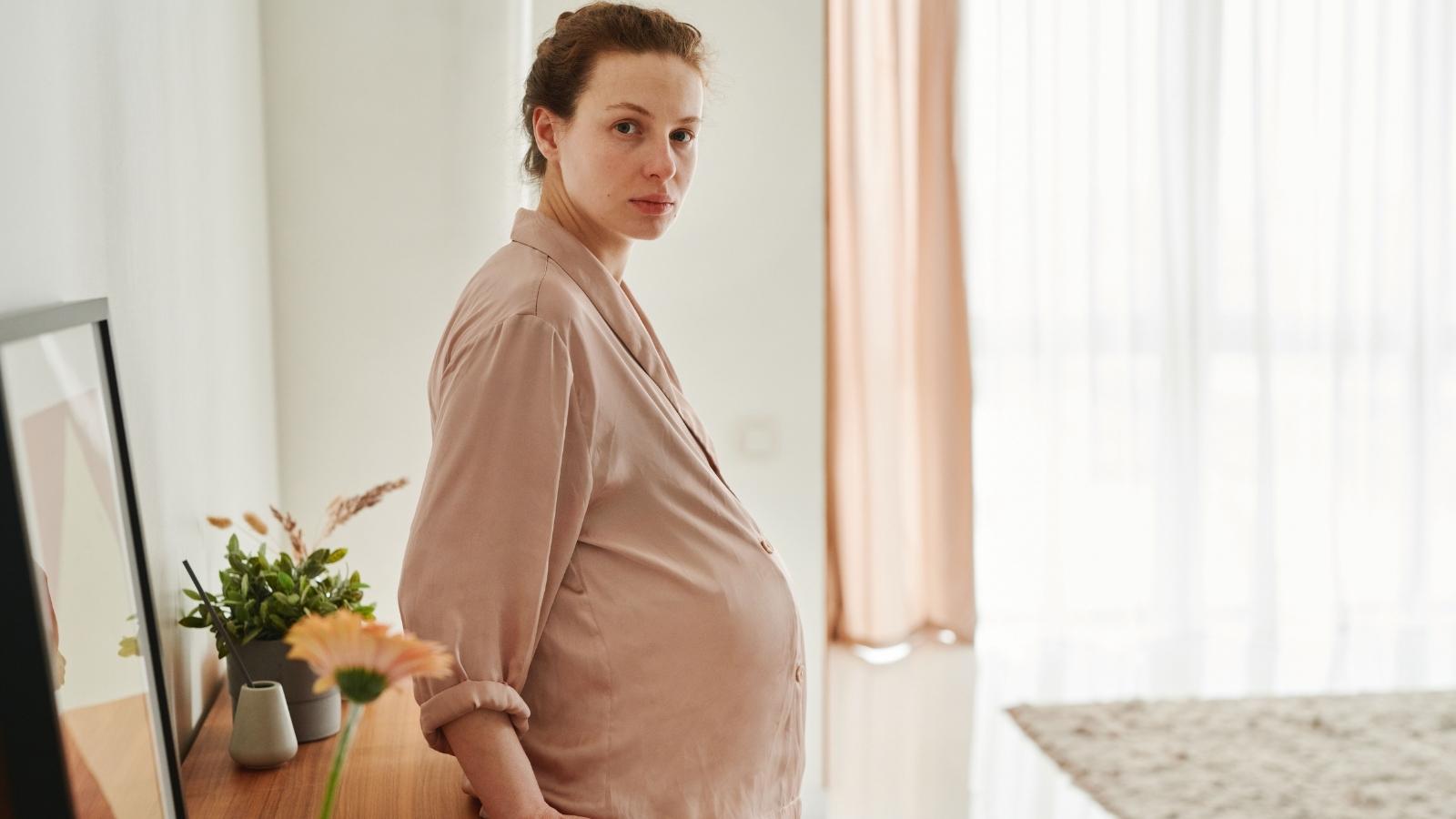 sad pregnant woman in her pajamas