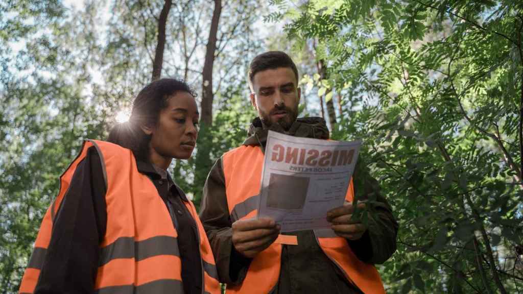 search party looking at a missing poster