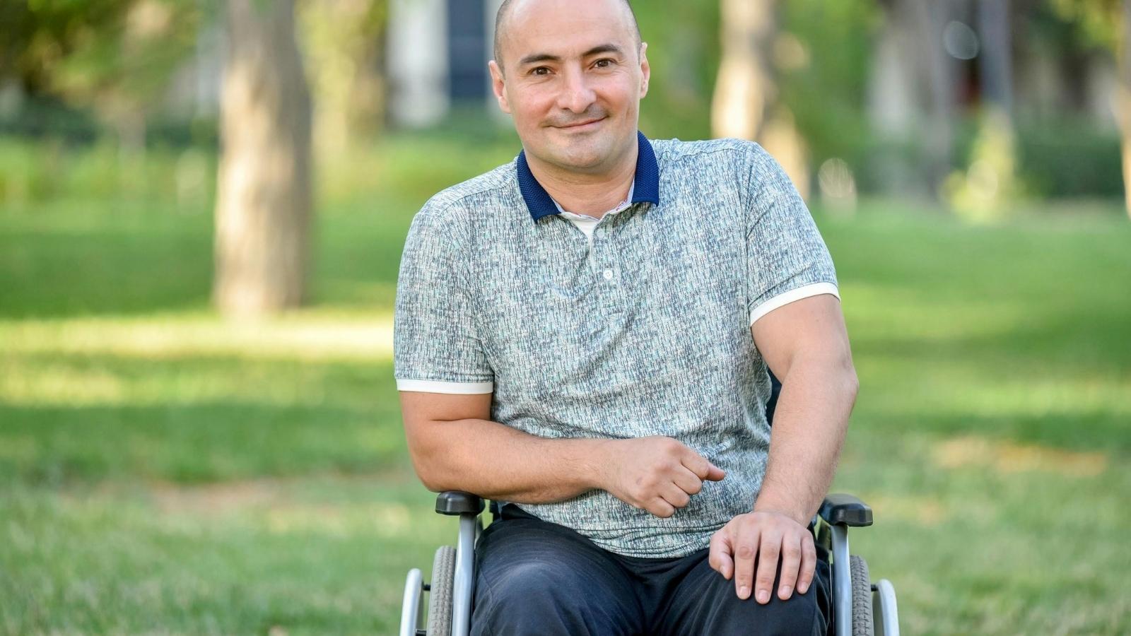 smiling man in a wheelchair