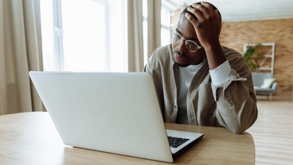 stressed man staring at his laptop