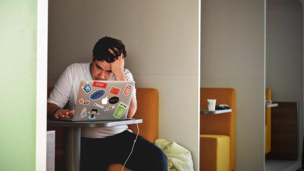 stressed man working on his laptop