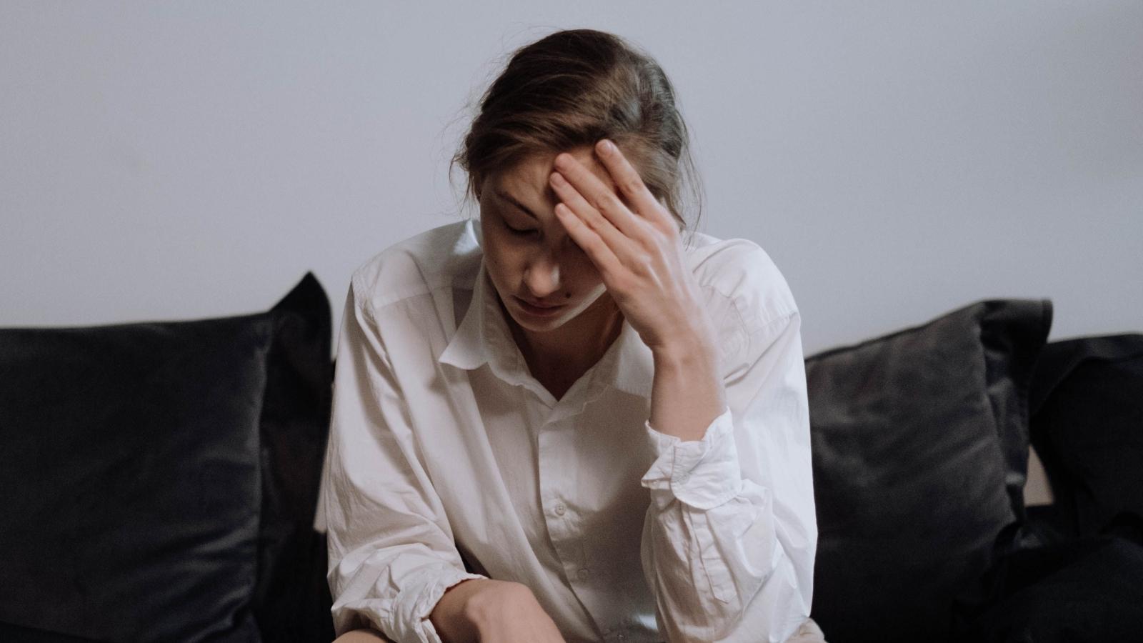 stressed woman sitting on the couch