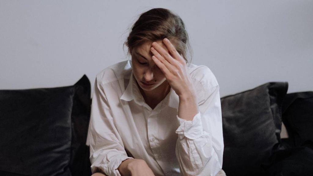 stressed woman sitting on the couch