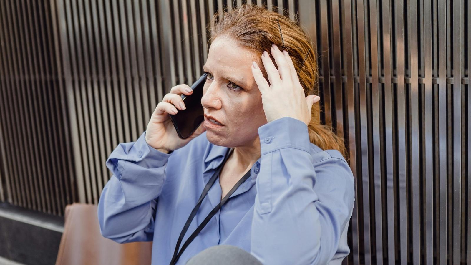 stressed woman talking on her cell phone