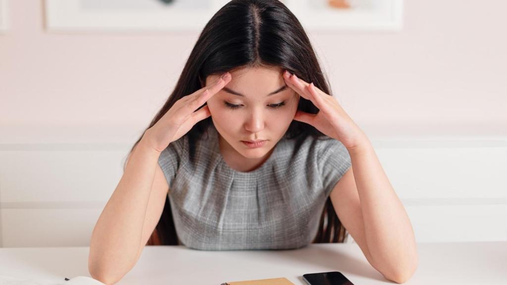 stressed young woman putting hands over head