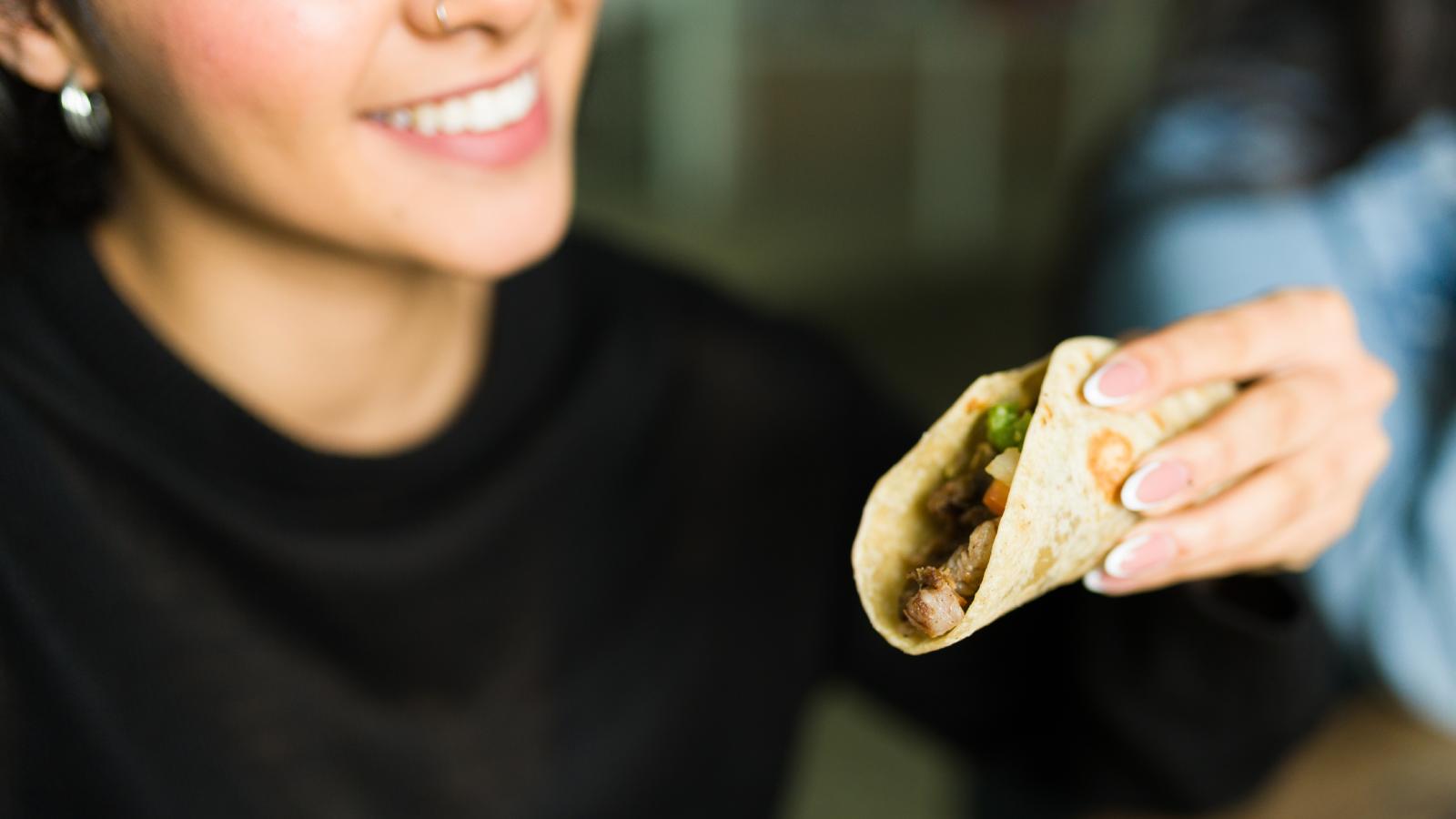 woman eating a taco