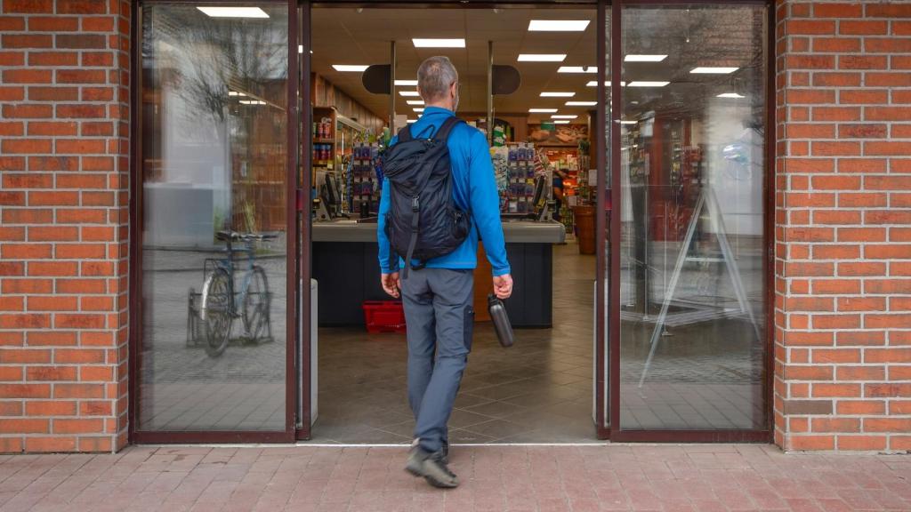 man walking into a store