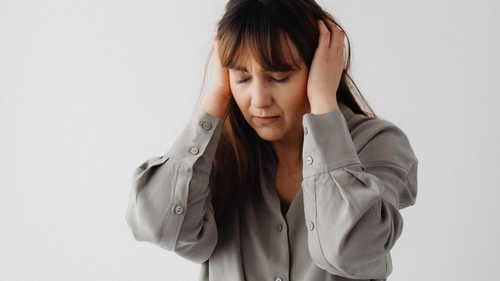 upset woman covering her ears