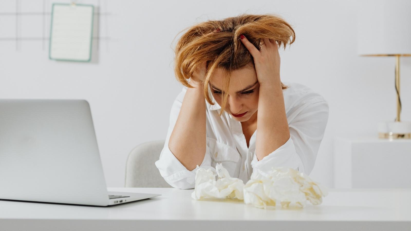 Office Drama: Woman Risks Her Job After Boss Refuses To Address Harassment upset woman sitting at her desk